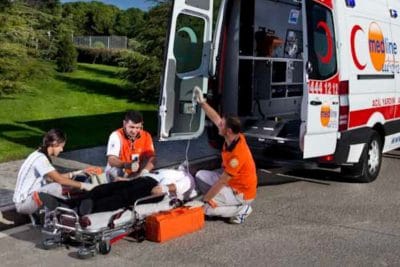 Medline medical crew transferring a patient into an ambulance